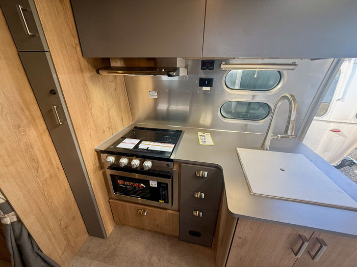 
New 2026 Airstream Trade Wind 25FBT Travel Trailer - Fieldstone Exterior - River Oak Interior - VIN: 1STJVYJ25TJ579989 - Stock #R60029