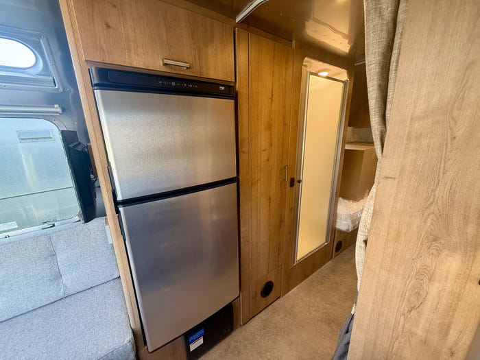 
New 2026 Airstream Trade Wind 25FBT Travel Trailer - Fieldstone Exterior - River Oak Interior - VIN: 1STJVYJ25TJ579989 - Stock #R60029