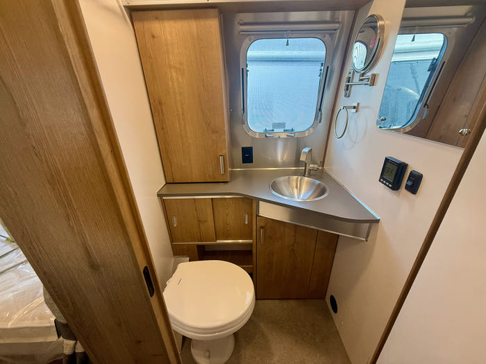 
New 2026 Airstream Trade Wind 25FBT Travel Trailer - Fieldstone Exterior - River Oak Interior - VIN: 1STJVYJ25TJ579989 - Stock #R60029
