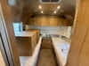 
New 2026 Airstream Trade Wind 25FBT Travel Trailer - Fieldstone Exterior - River Oak Interior - VIN: 1STJVYJ25TJ579989 - Stock #R60029
